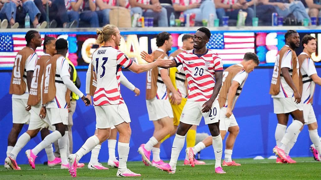 USMNT players celebrate after scoring a goal against Paraguay at the World Cup.