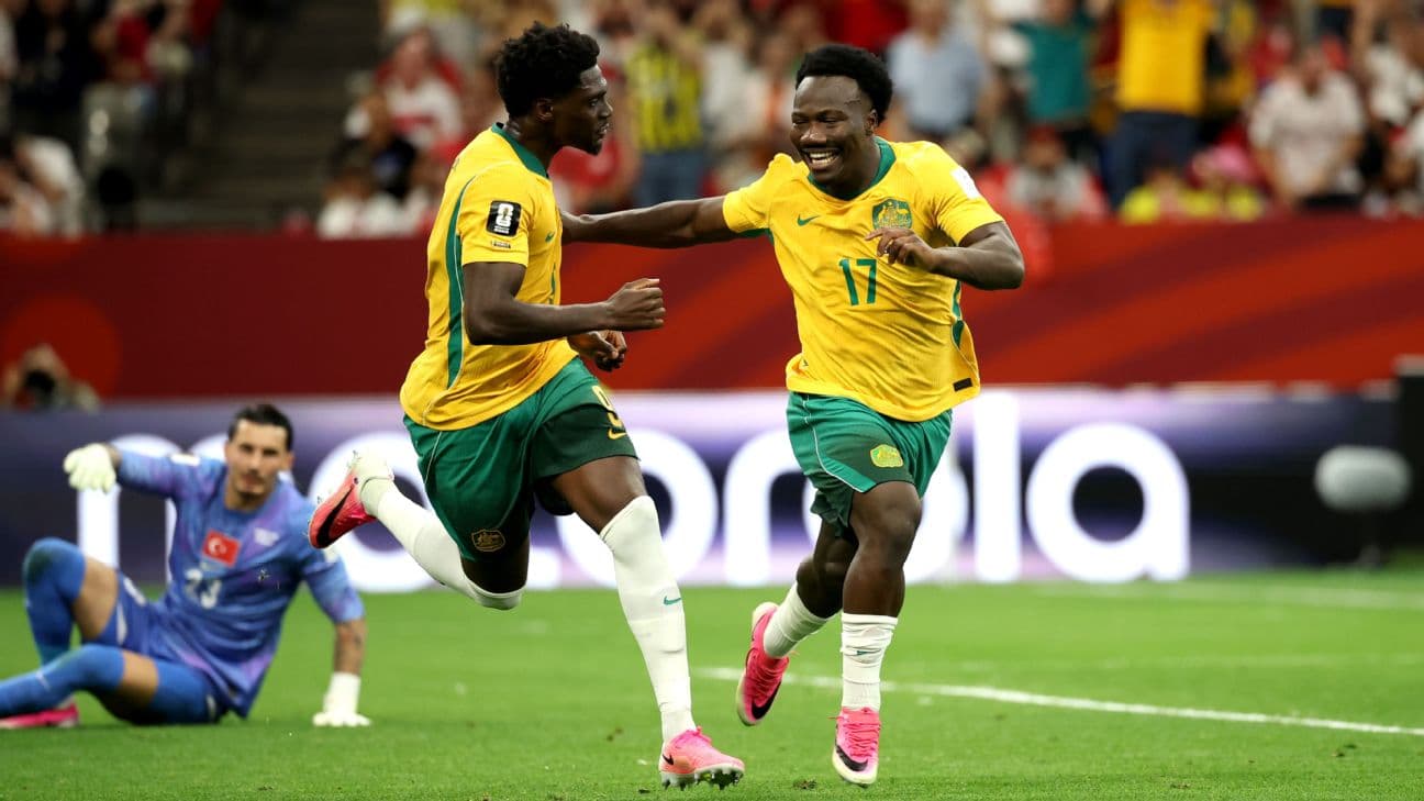 Nestory Irankunda celebrates with teammate Mohamed Toure after scoring Australia's opening goal against Türkiye.