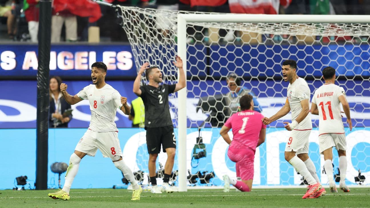 Iran players celebrate after scoring a goal against New Zealand at the World Cup.